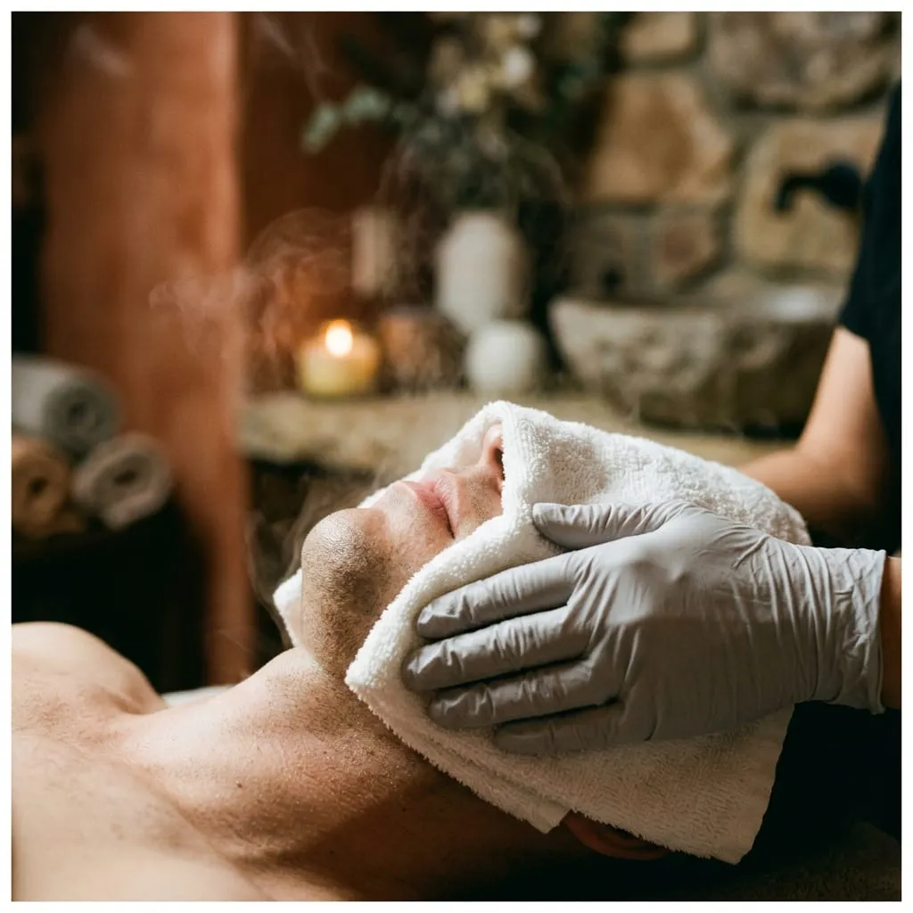 Warm compress laid over the face during a deep cleansing facial — Sweet & Smile Massage, Daly City